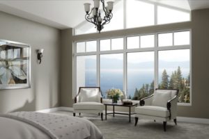 A wall of white-frame windows in a bedroom.